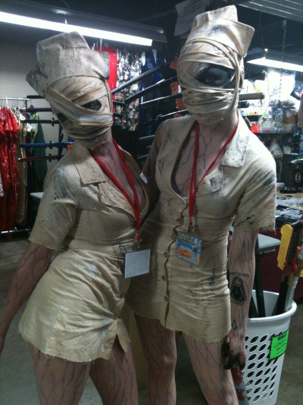 two mannequins dressed as nurses are standing next to each other in a store