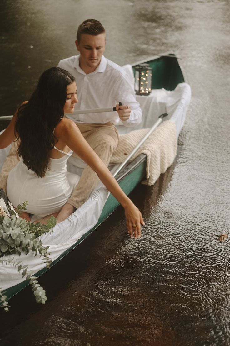 a man and woman sitting in a small boat