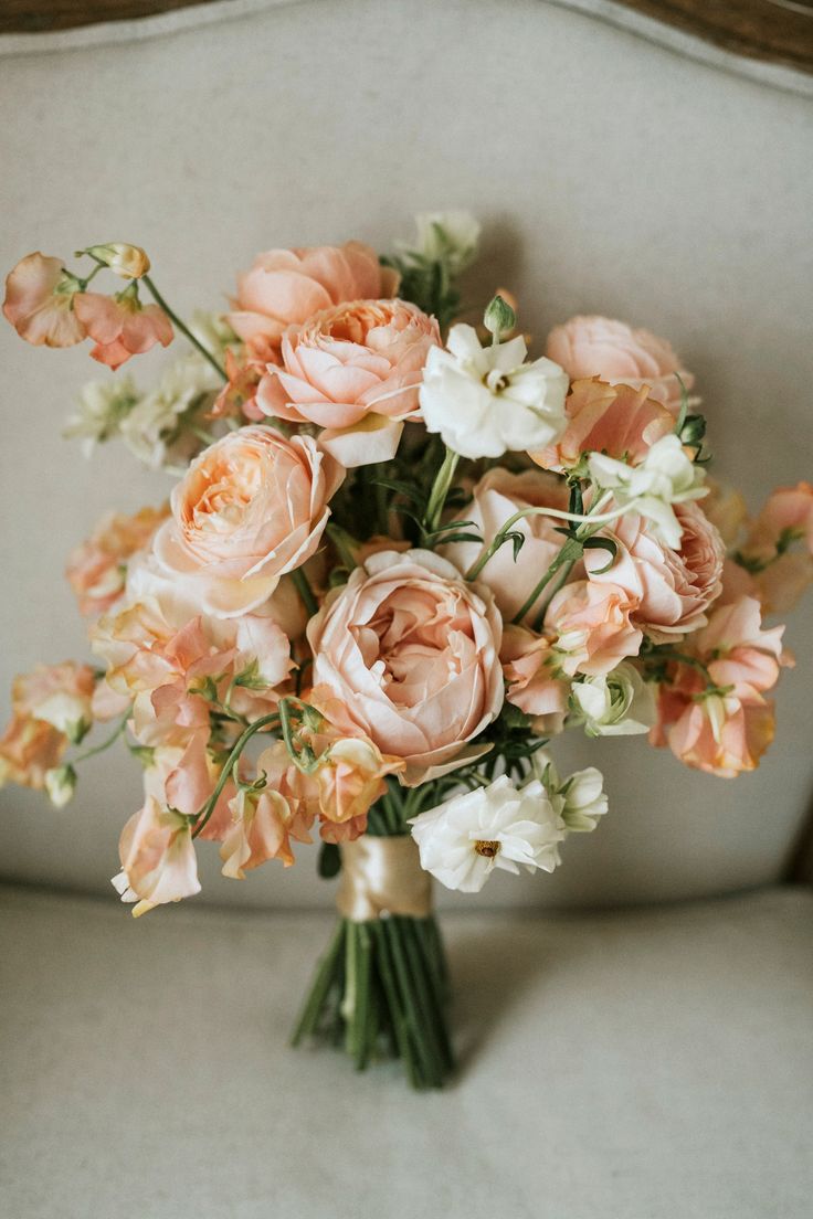 a bouquet of flowers sitting on top of a couch