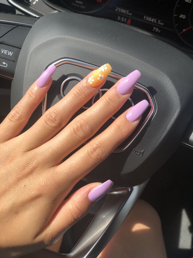 Light lavender purple set with one nail of peach orange with simple, cute white flowers✨✨✨ Purple And Yellow Nail Ideas, Orange And Lavender Nails, Light Purple And Yellow Nails, Light Purple And Orange Nails, Lavender And Orange Nails, Peach And Purple Nails, Lavender And Yellow Nails, Nails Purple And Orange, Lilac And Yellow Nails