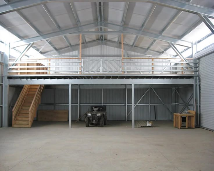 an empty garage with stairs and railings