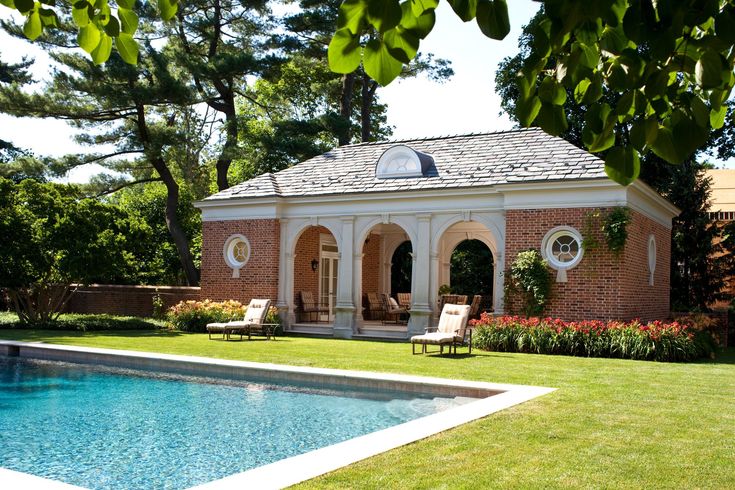 an outdoor pool and gazebo with chairs around it