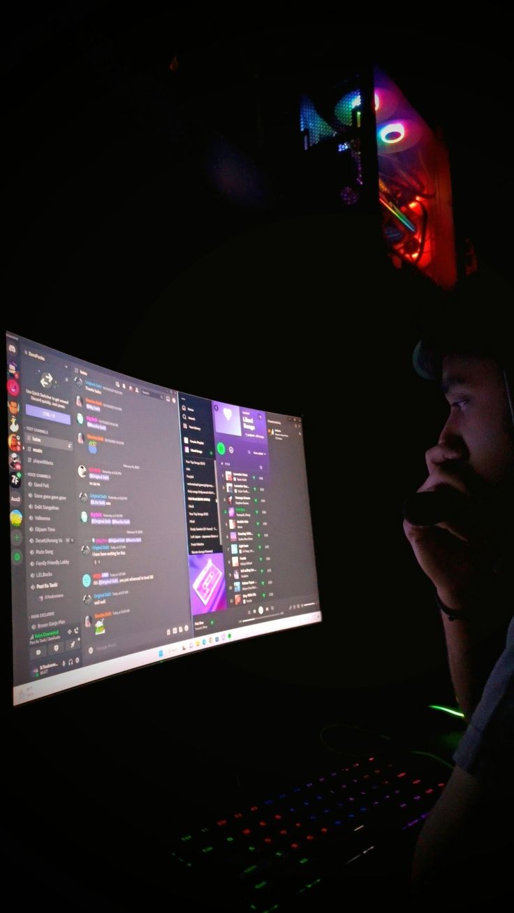 a man sitting in front of a computer screen