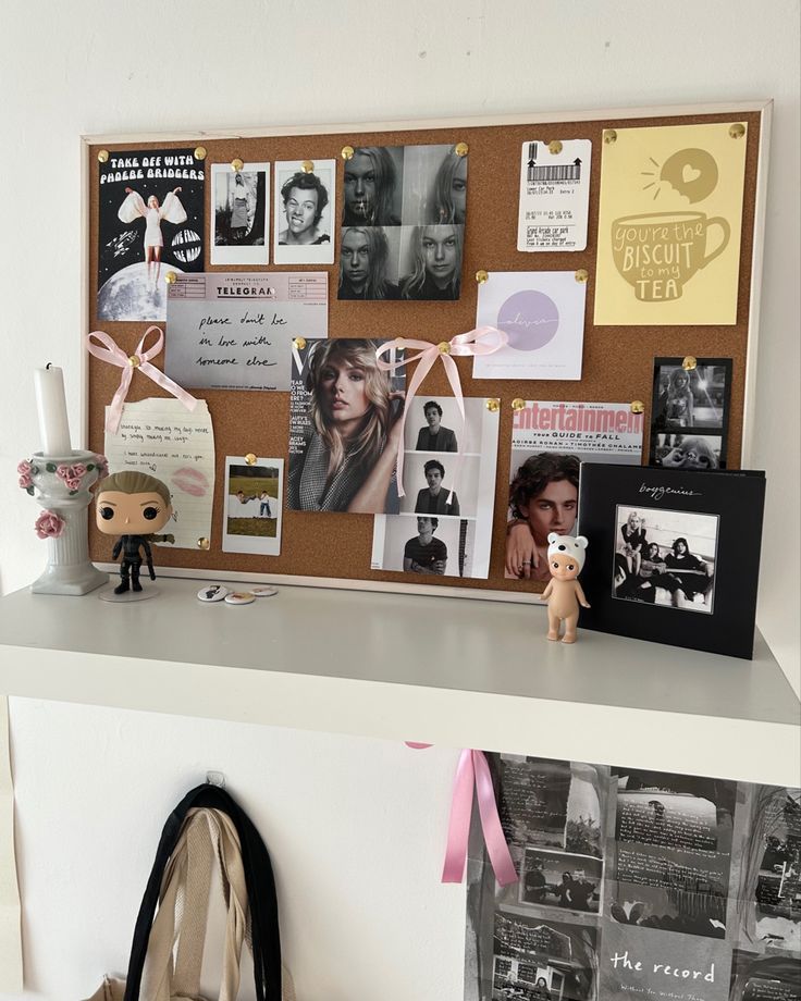 a bulletin board with pictures, photos and a teddy bear sitting on top of it