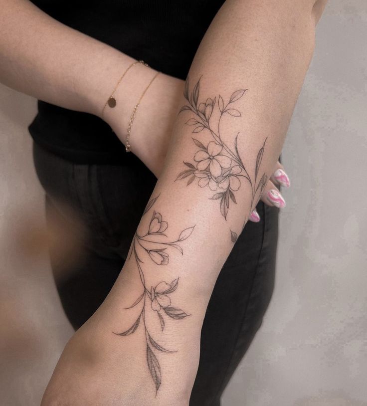 a woman with a flower tattoo on her arm