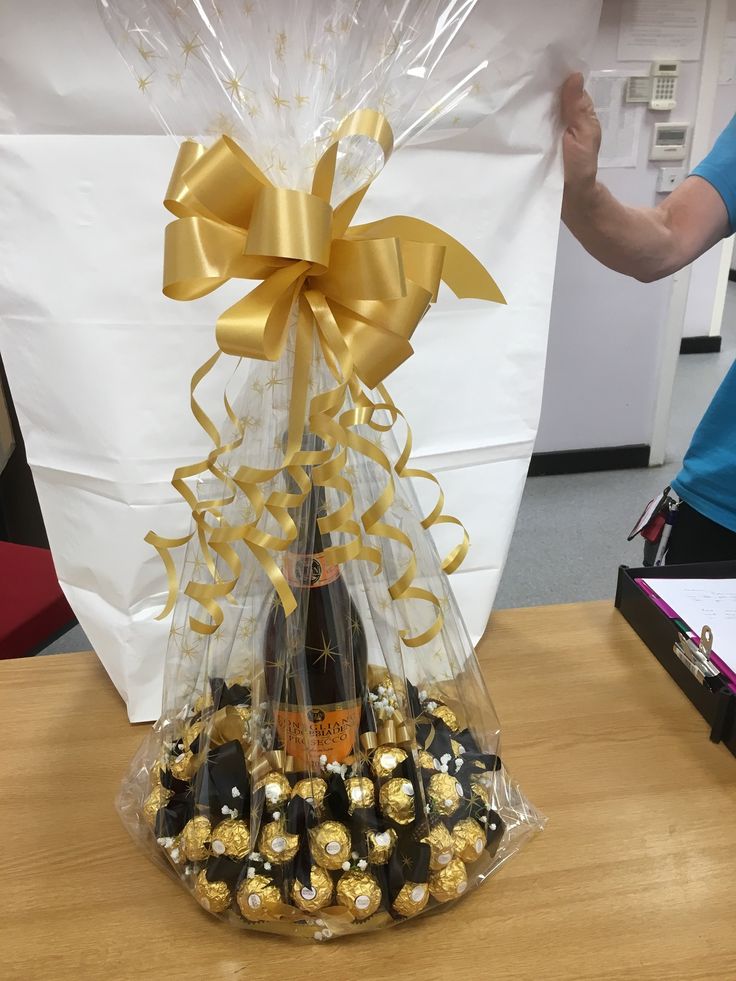 a basket filled with chocolates on top of a wooden table