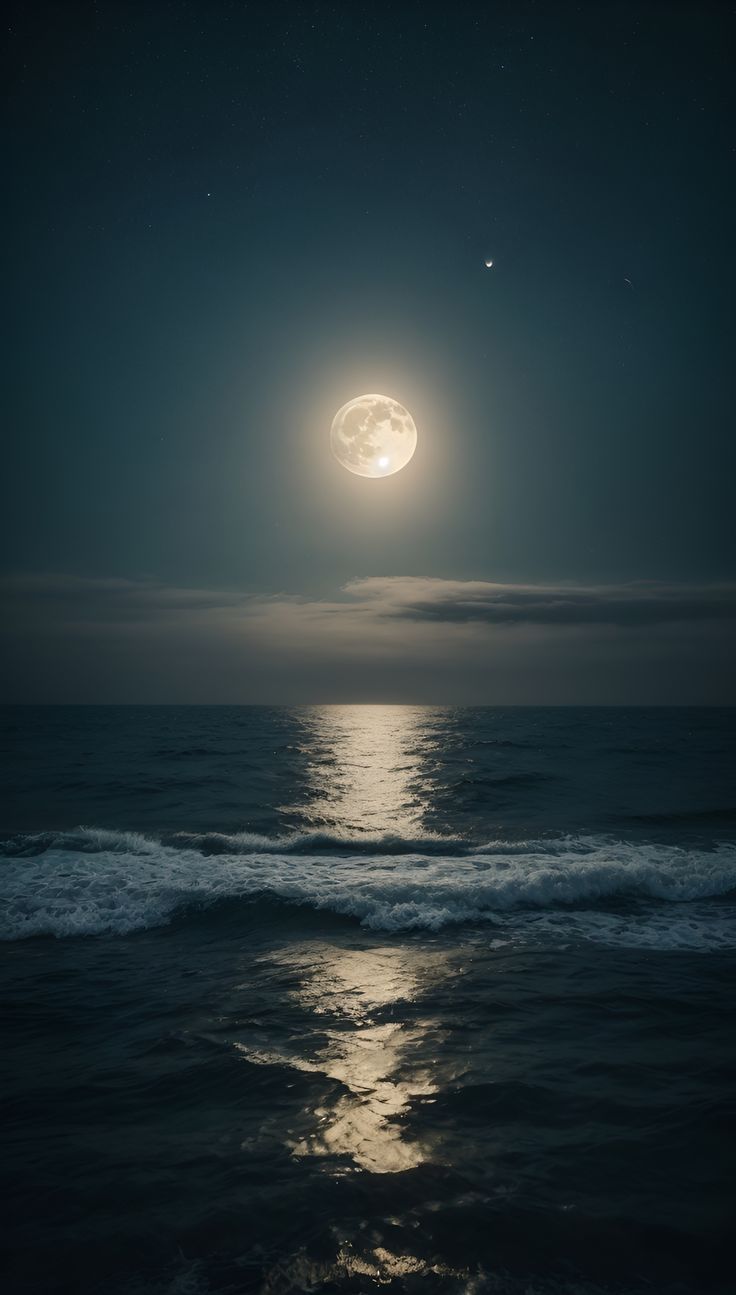 the moon is shining over the ocean at night