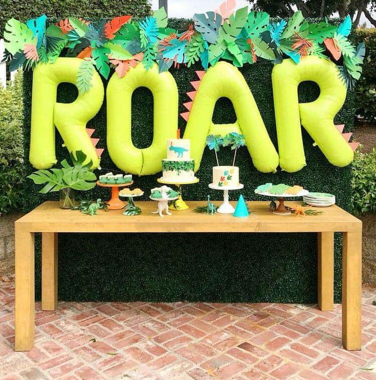 a table topped with an air filled sign and cake