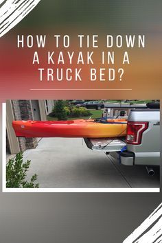 a red kayak sitting on the back of a truck