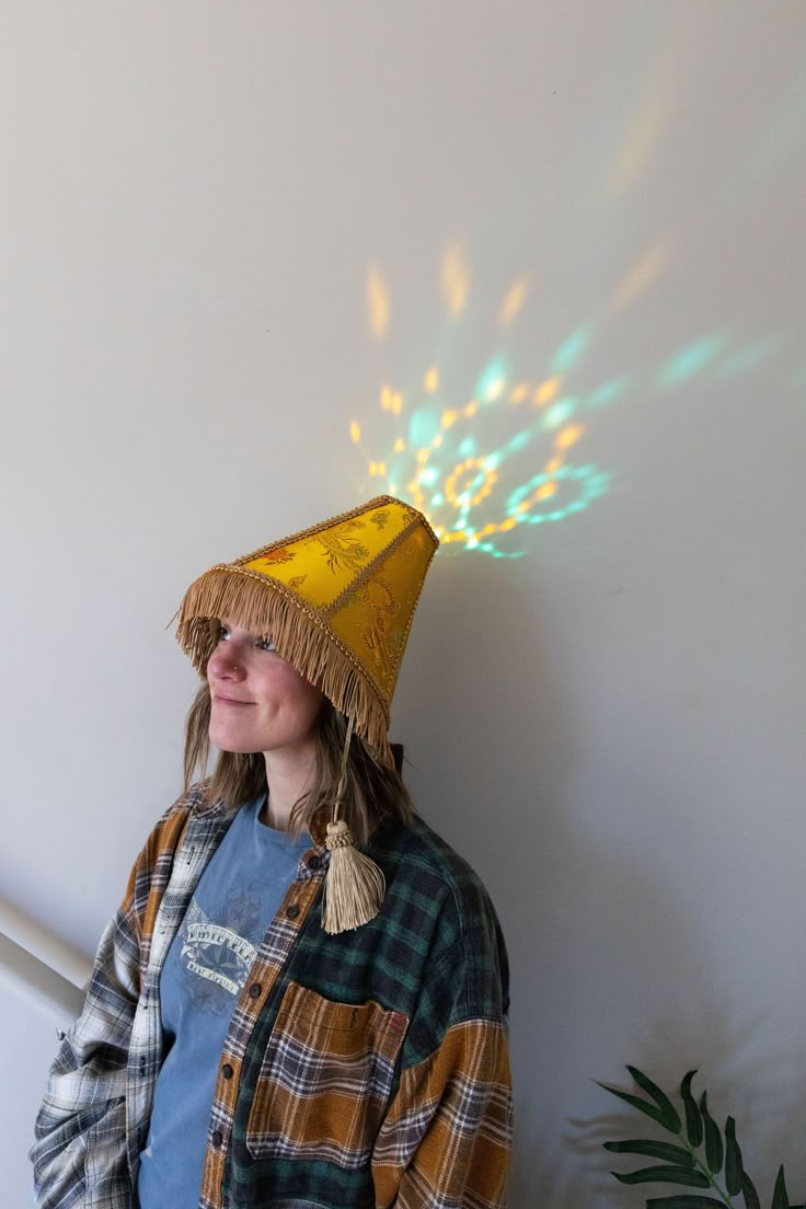 a woman wearing a yellow hat with lights coming out of it's back end