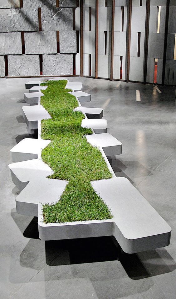 a bench with grass growing out of it