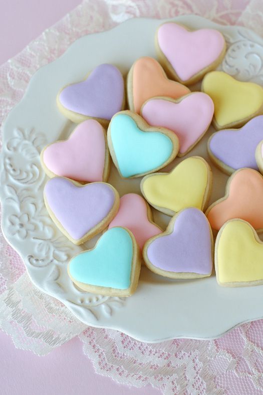 some heart shaped cookies are on a plate