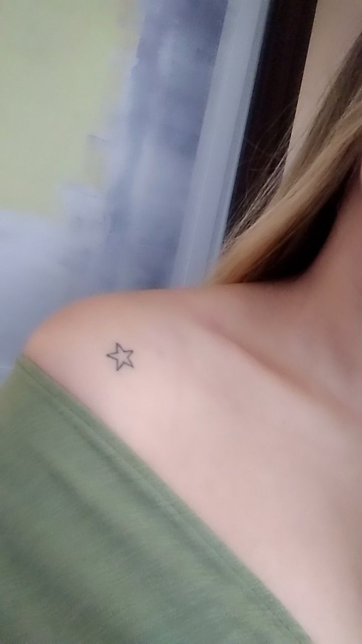 a woman with a small star tattoo on her left shoulder