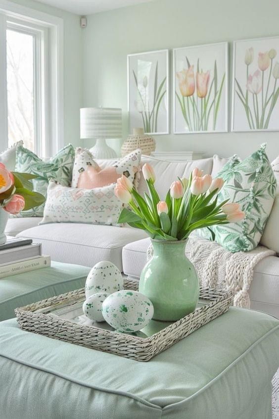 a living room filled with furniture and flowers in a vase on top of a coffee table