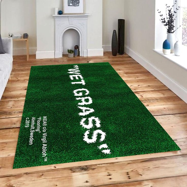 a green area rug with white writing on it in the middle of a living room