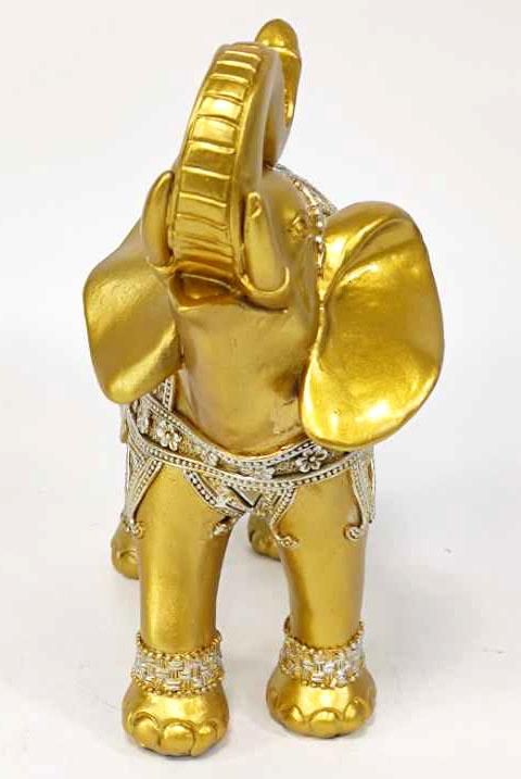 an elephant figurine is shown in gold