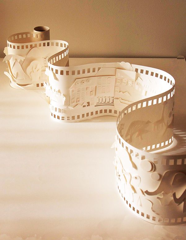 three white bowls sitting on top of a table with film strips around the rims