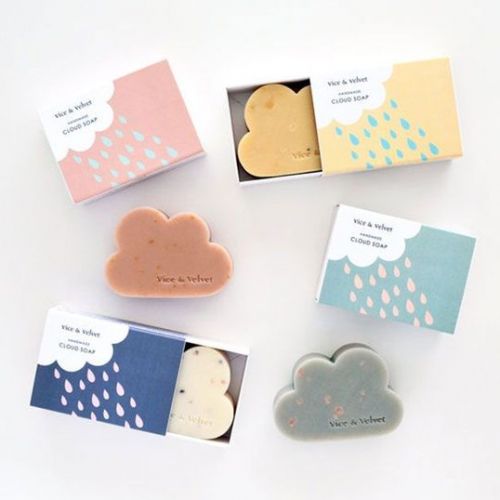 four soaps in boxes with rain and cloud designs on them, sitting next to each other