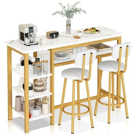 a kitchen table with two stools next to it and an open shelf on the side