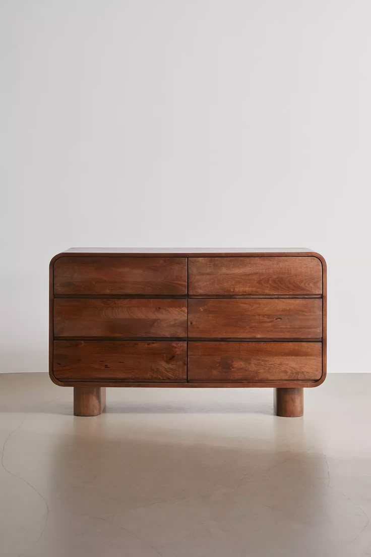 a wooden dresser sitting on top of a white floor