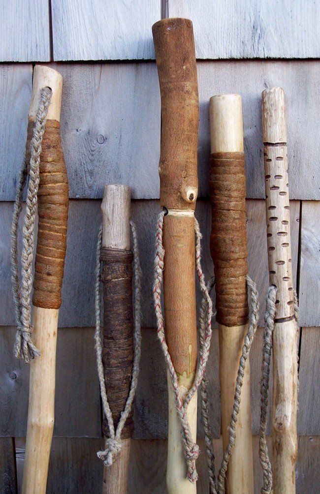 several different types of roped objects hanging on a wall with wood planks in the background