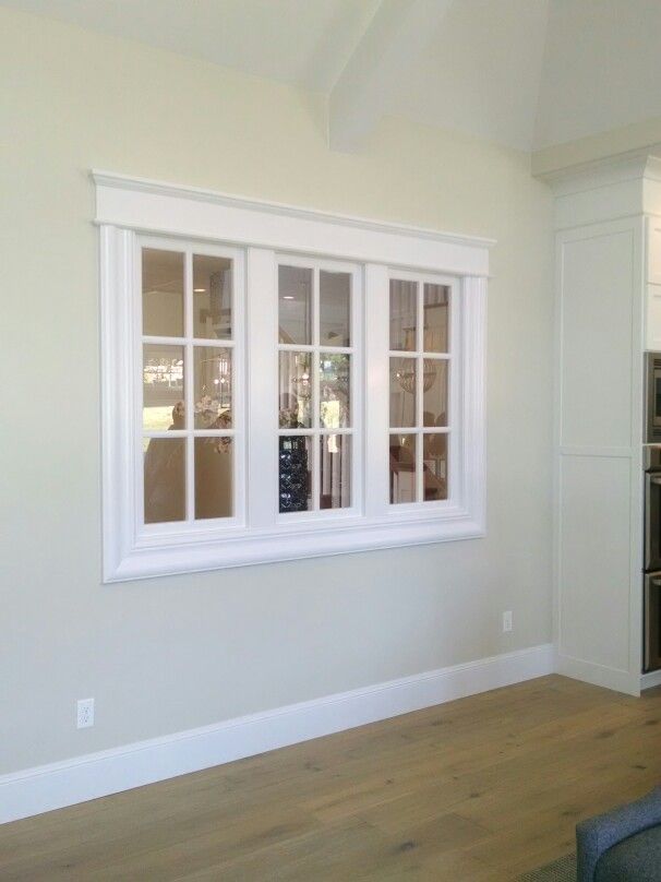 an empty living room with white walls and windows