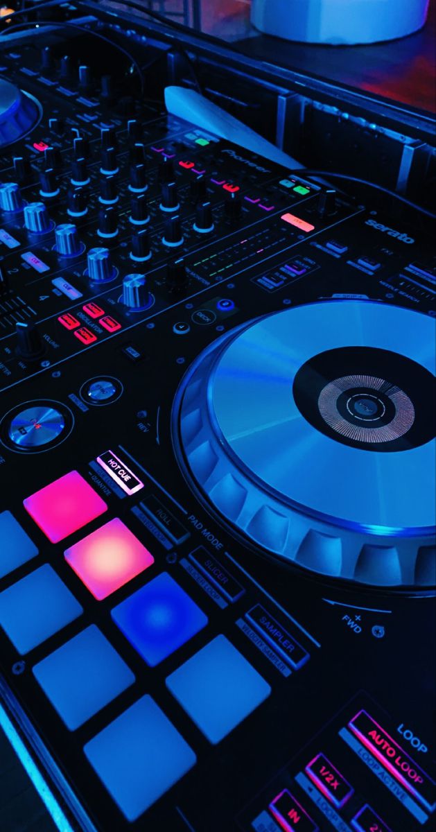 a close up of a dj's turntable with blue lights on the side