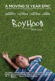 the boyhood movie poster with a young boy laying on grass in front of him