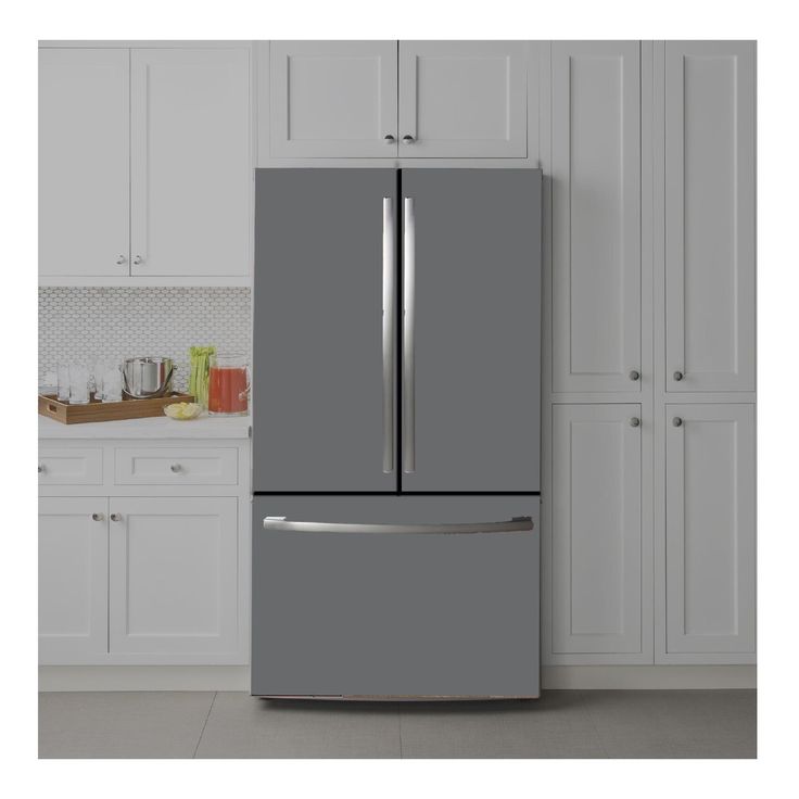 a gray refrigerator freezer sitting in a kitchen next to white cupboards and cabinets