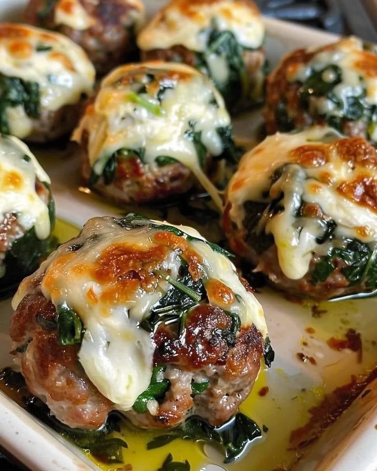 spinach and cheese stuffed meatballs on a plate