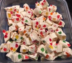 a plastic container filled with lots of white and multicolored marshmallows