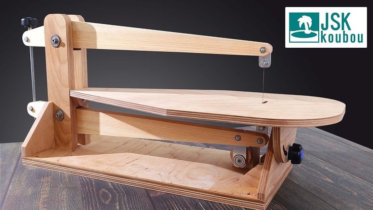 a wooden work bench with two tools attached to it