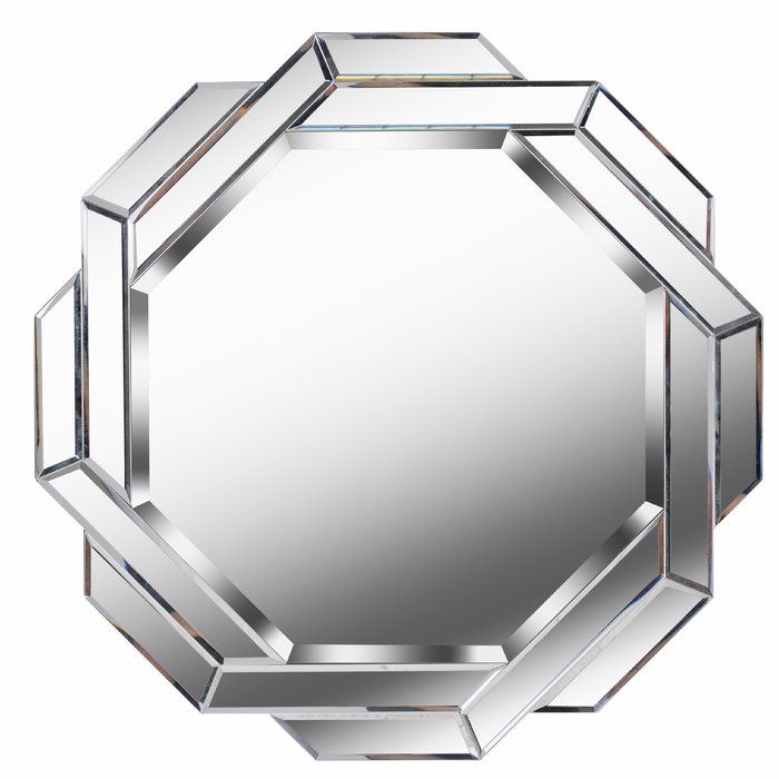 a mirror that is sitting on top of a white surface and has silver trim around the edges