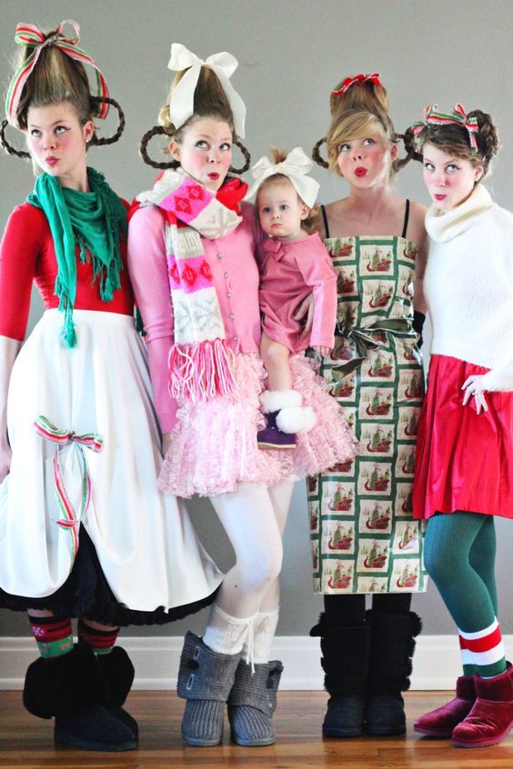 three women and two children are dressed up in costumes for the holiday season, standing next to each other