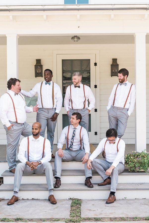 a group of men wearing ties and suspenders posing for a photo on the steps