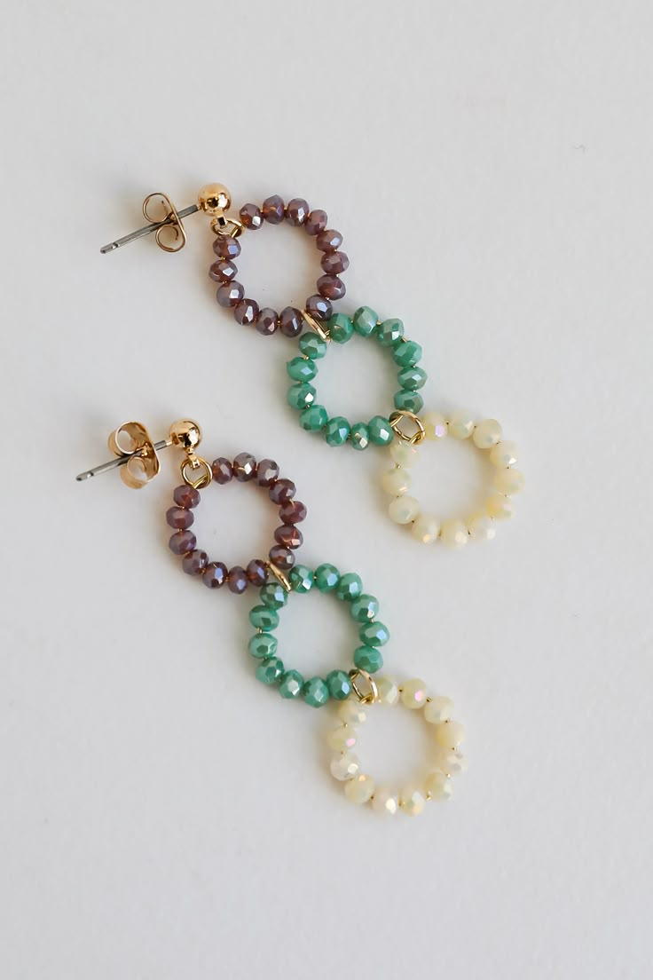 The finishing touch to all your best looks is the Melissa Teal Beaded Circle Drop Earrings! These trendy gold earrings start with a stud post back and fall to colorful beaded circles. Add these fun earrings to a floral dress + sandals to add a girly touch to your look! Gold Plated Beaded Circles Stud Post Back One Size | Length 2”