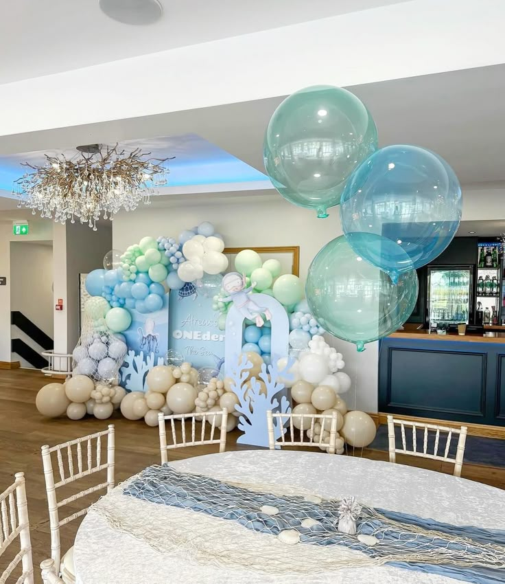 balloons and decorations are on display in the dining room at a wedding or baby's first birthday party