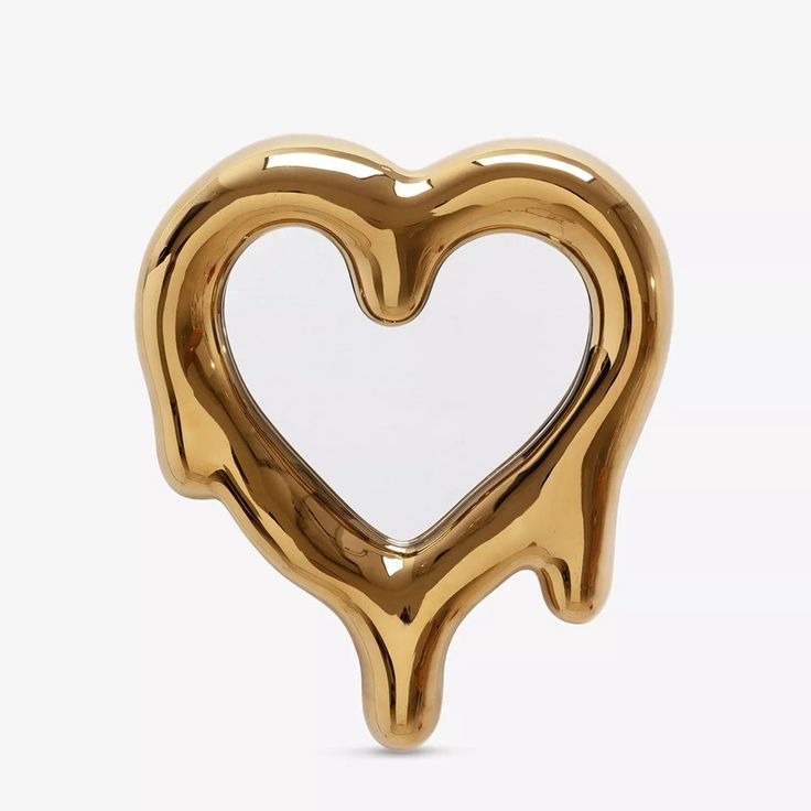 a gold heart shaped object on a white background