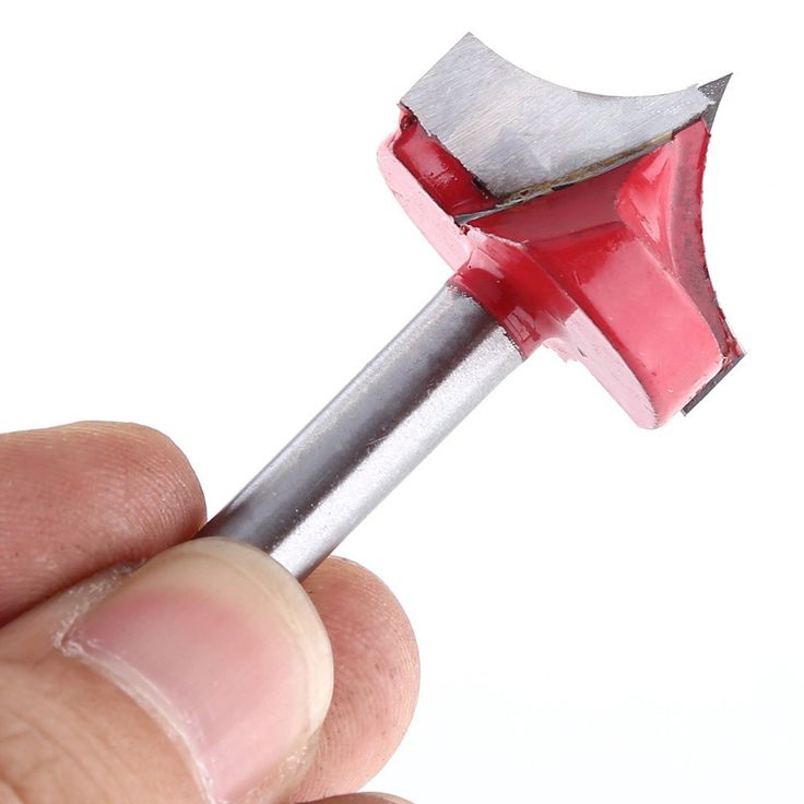 a hand holding a red and silver hammer