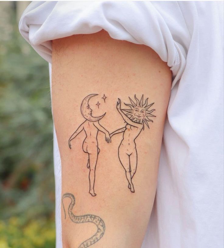 a woman with a tattoo on her arm holding the hand of a man that has a snake in it