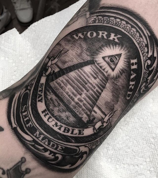 a man's arm with an all seeing eye and work hard tattoo on it