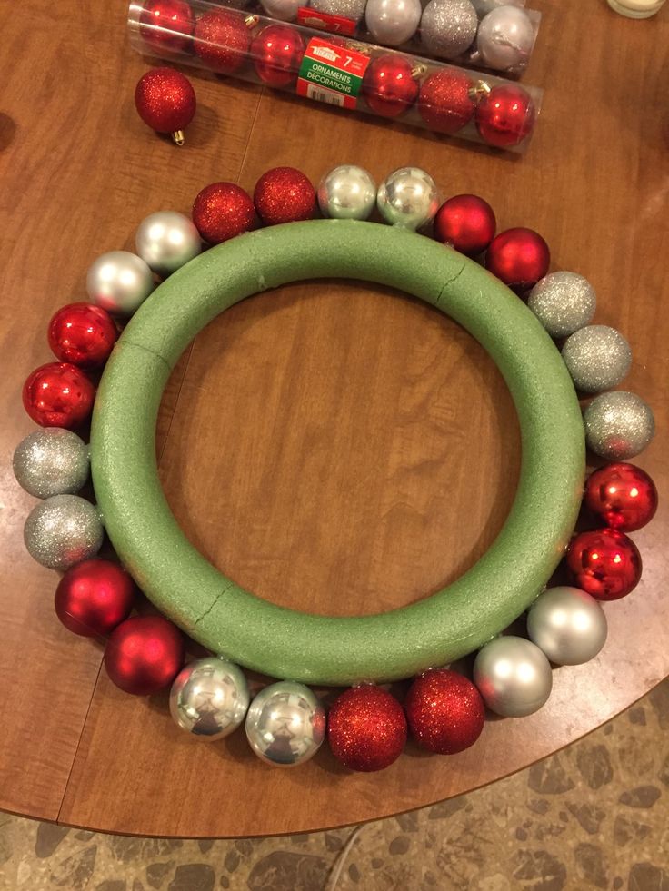 a christmas wreath made out of ornaments on top of a table