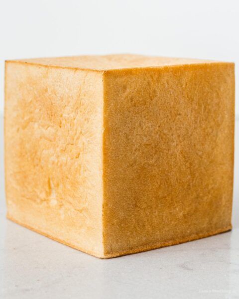 a block of yellow soap sitting on top of a white counter