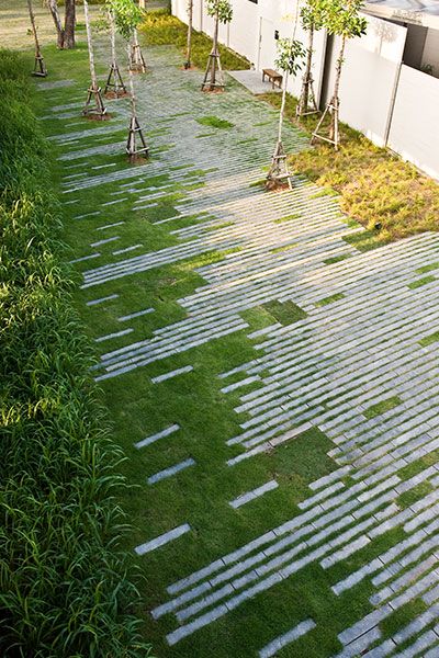 an outdoor walkway with grass and trees in the background