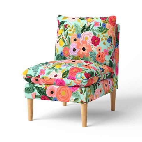 an upholstered chair with colorful flowers on it