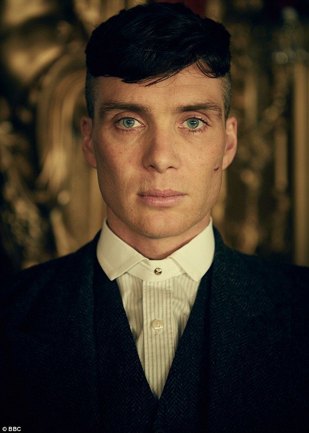 a close up of a person wearing a suit and tie with an intense look on his face