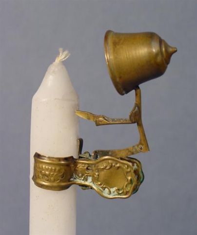 a gold ring on top of a white candle