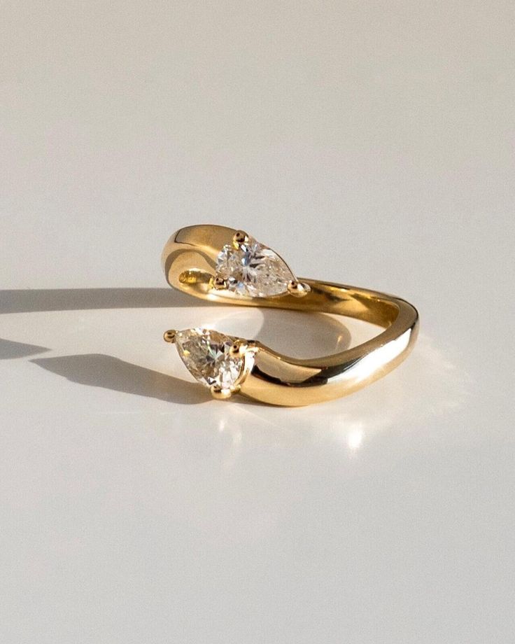 two yellow gold rings with diamonds on them