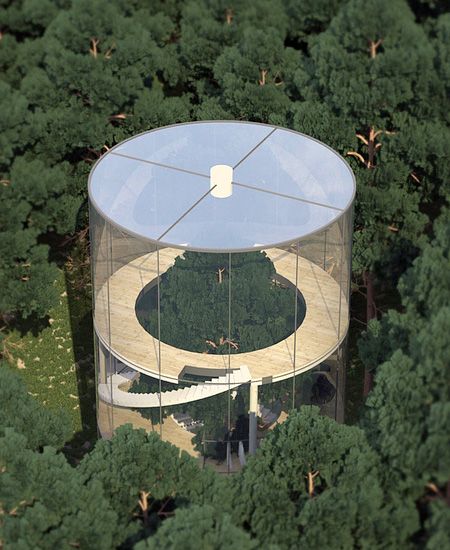 an aerial view of a building in the middle of a forest with trees around it