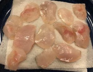 raw fish fillets on a cloth in a bowl